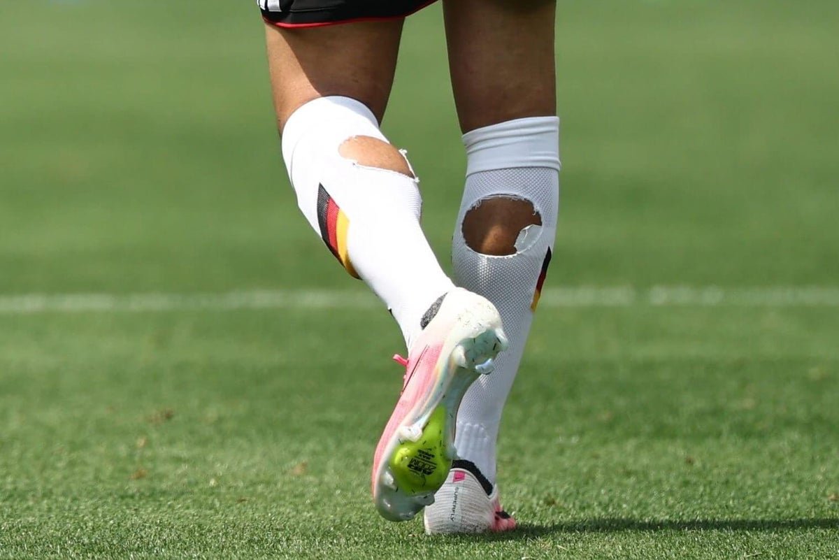 Why are World Cup players cutting holes in their socks?
