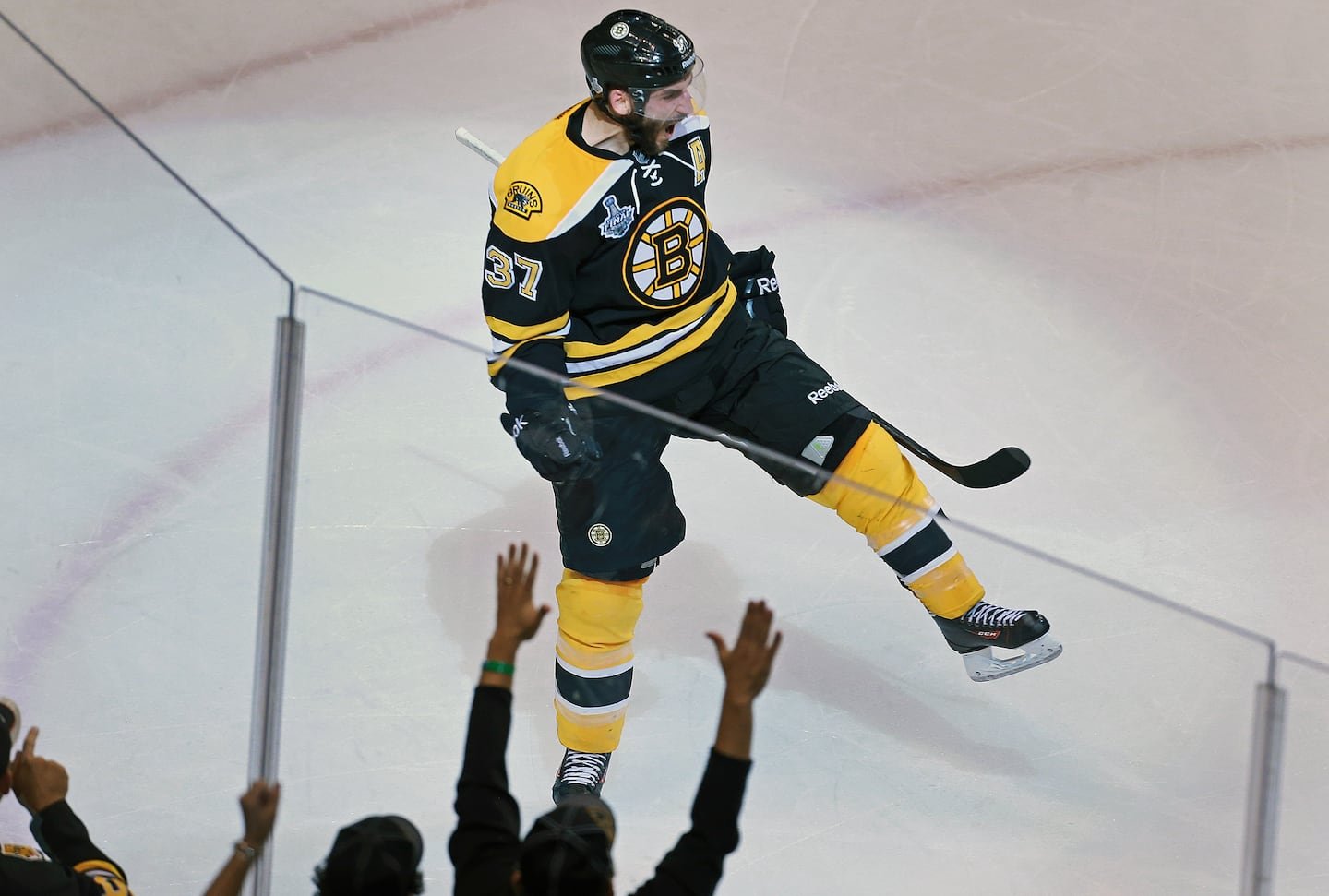 Patrice Bergeron, pictured here in 2013, ranks high on the Bruins' all-time lists, including third in goals (427), points (1,040), and games (1,294).